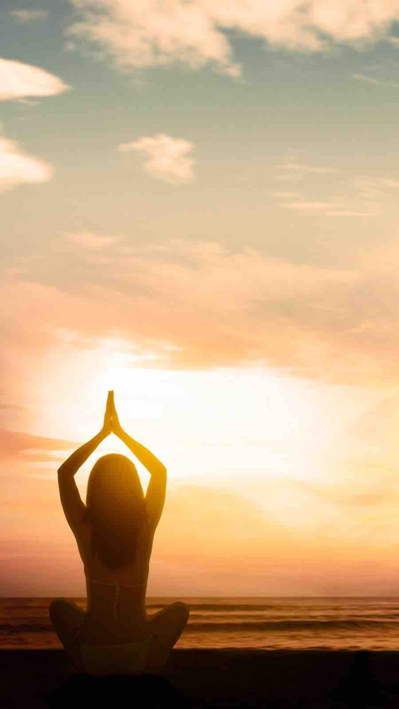 silhouette,of,young,woman,exercising,yoga,while,doing,meditation,at
